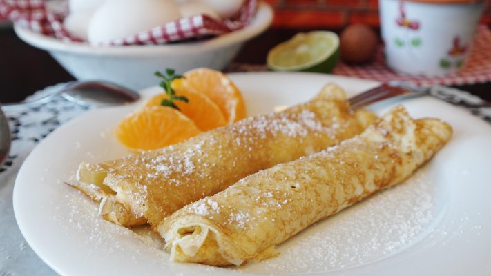 crêpe on a plate with orange slices