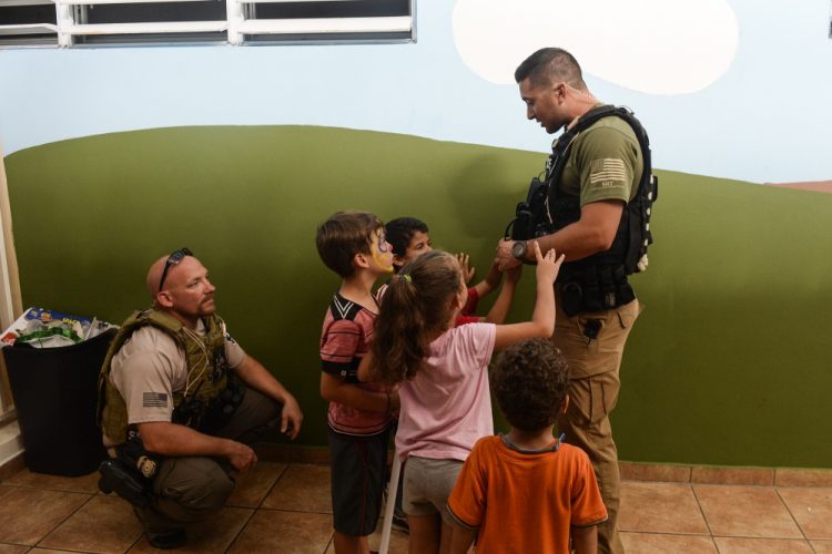 children talking to a soldier