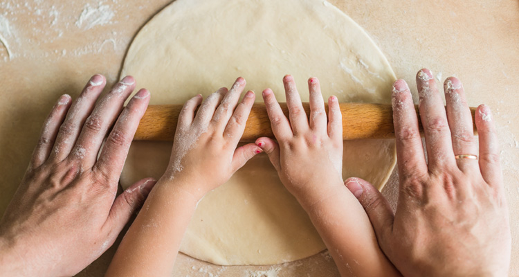 Children and dad hands rolled dough