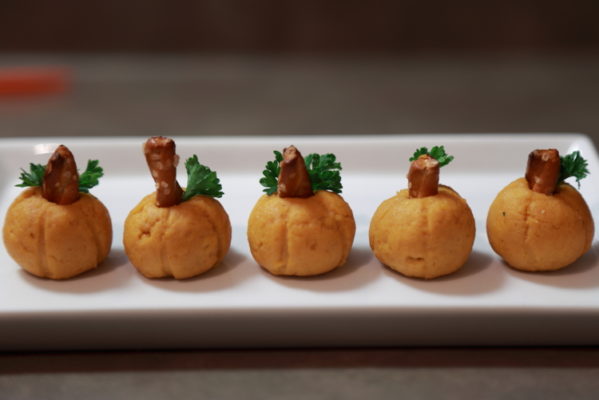 pumpkin shaped cheeseballs on a plate