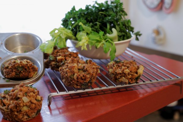 Stuffing muffins on a tray with vegetables