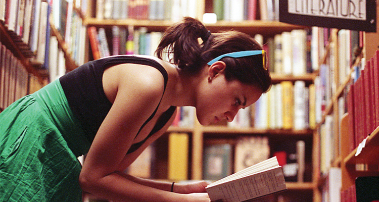 photo of student reading book in library