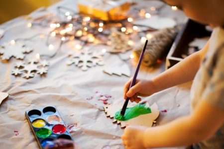 child doing holiday crafts