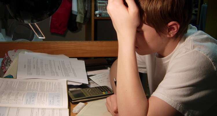 child at desk with homework