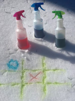 spray bottles with tic tac toe sprayed in snow