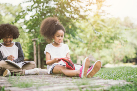 children reading outside