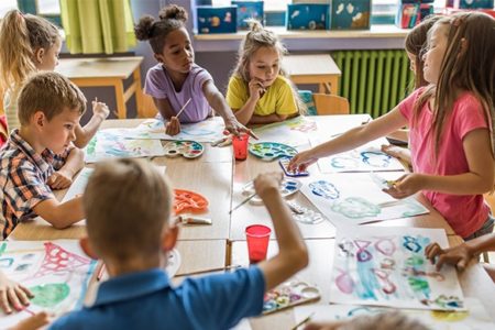 Large group of elementary students having an art class in the classroom