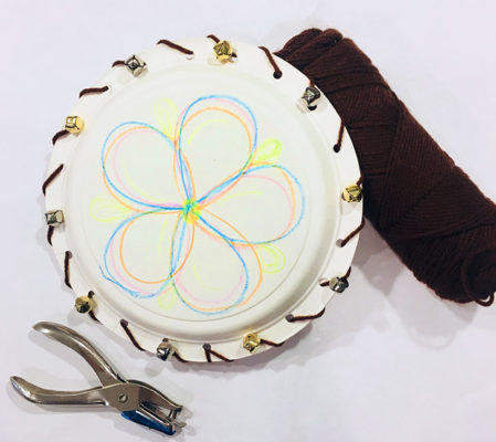 decorated paper plate with hole puncher