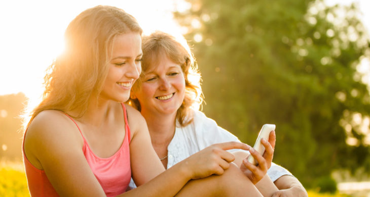 mom and teen looking at cell phone