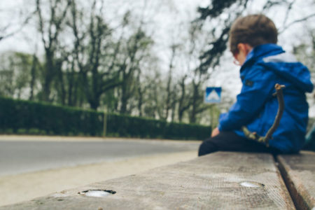 sad kid on bench