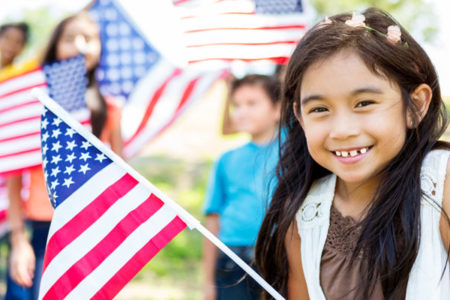 little girl holds American Flag