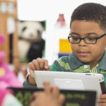 little boy using tablet