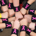 baseball players wearing breast cancer awareness wristbands