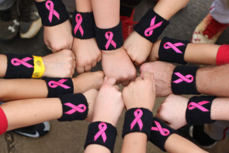 baseball players wearing breast cancer awareness wristbands