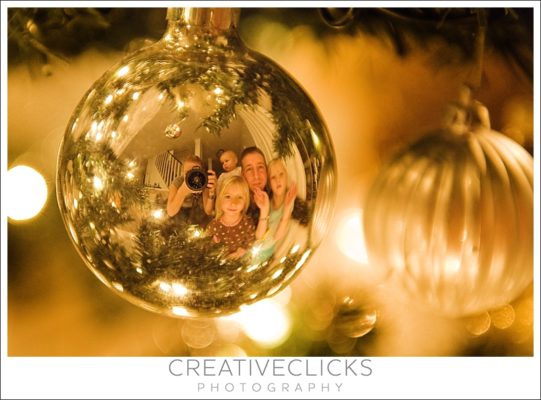photo of a family reflected in a christmas bulb