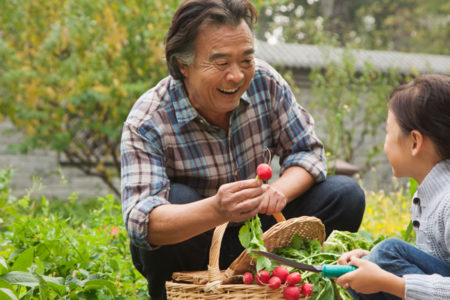 Grandfather and granddaughter in garden