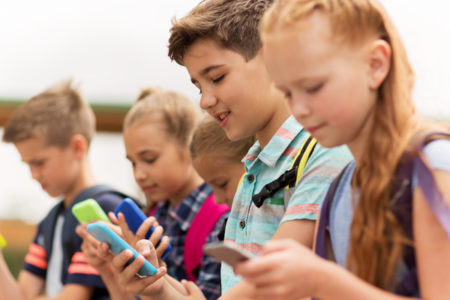 group of kids using smartphones
