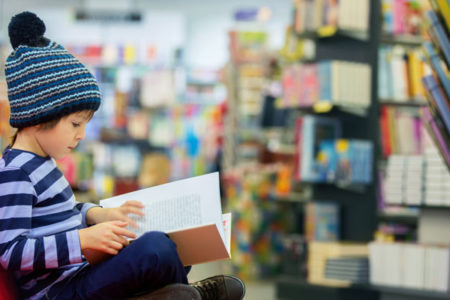 high IQ child reading in bookstore