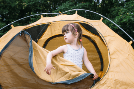 child in tent for family camping