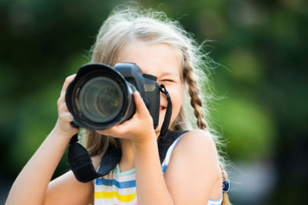 kid with camera taking nature photos