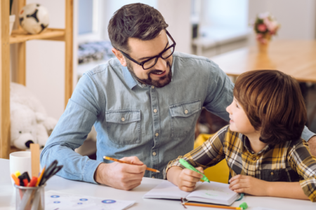 father helping child with homework