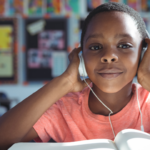 child wearing headphones while studying in class