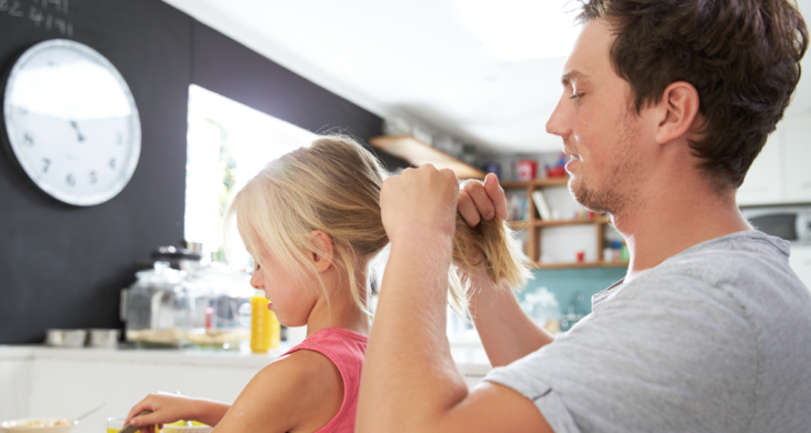 Father Styling Daughter's Hair At Breakfast Table