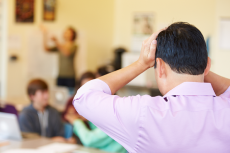 Stressed High School Teacher Trying To Control Class