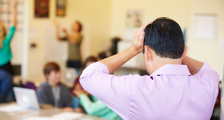 Stressed High School Teacher Trying To Control Class