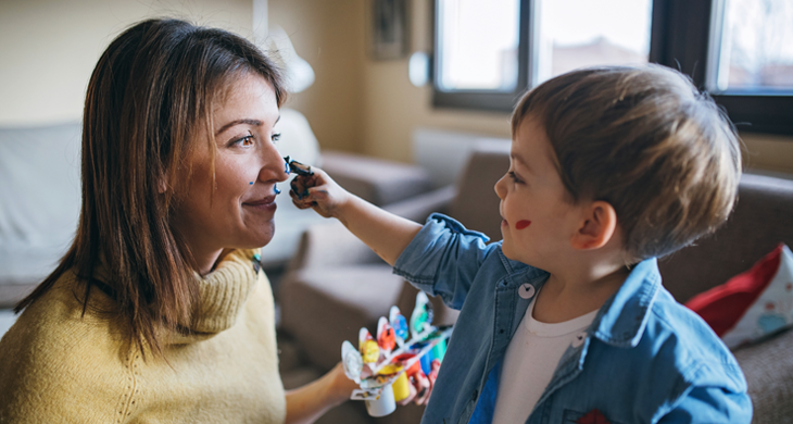 Mother and son having fun with finger paint