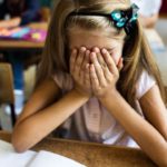 Girl at school looking upset