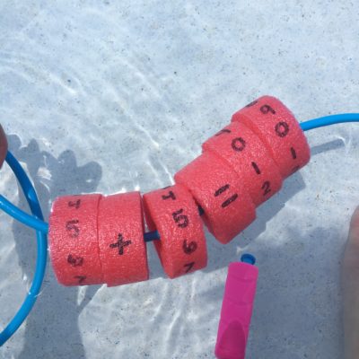 inflatables with numbers floating in pool