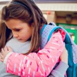 mother consulting child outside of school