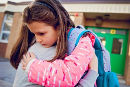 mother consulting child outside of school