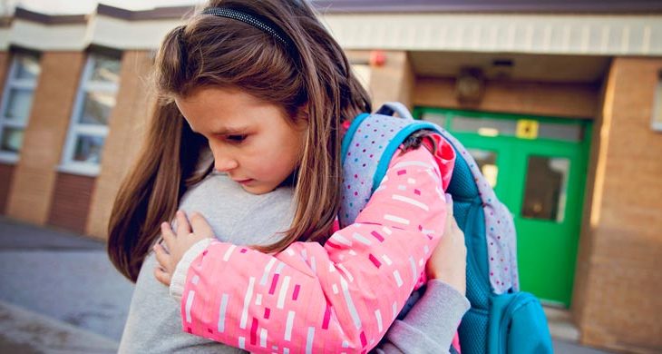 mother consulting child outside of school