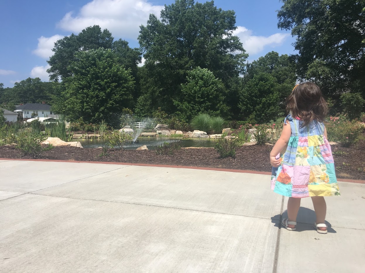 girl looking at a pond