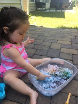child playing with ice cubes
