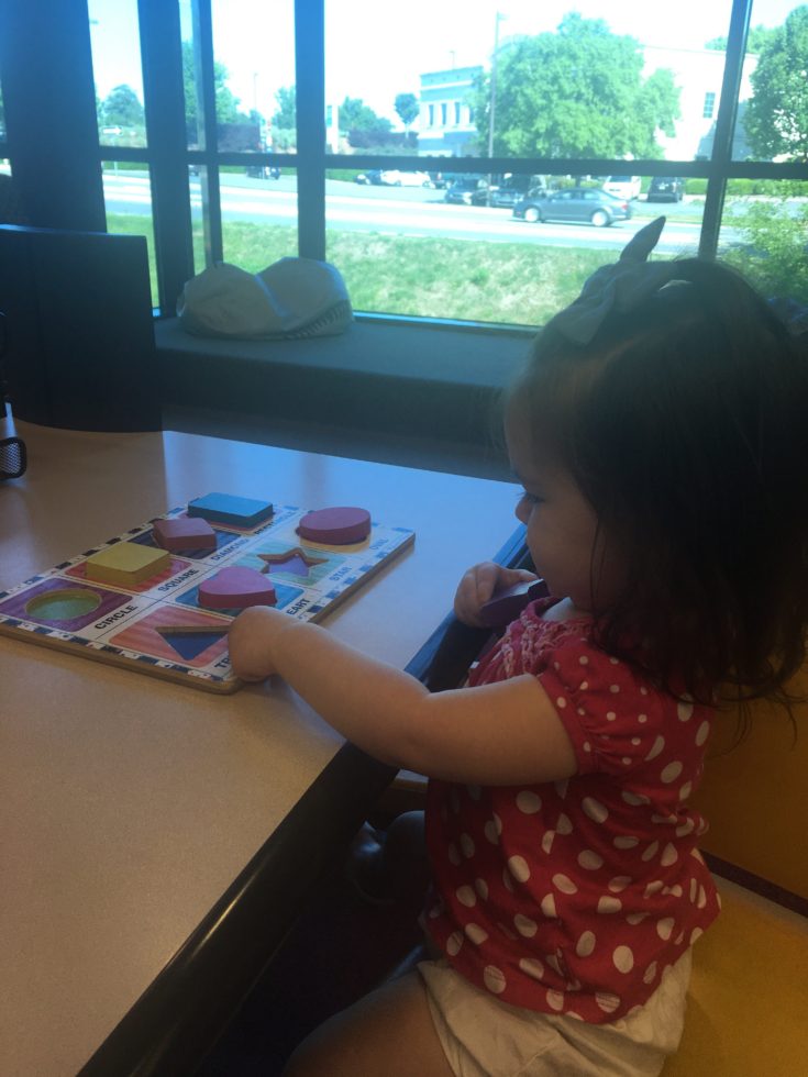 child playing with a puzzle