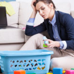 Stressed looking mother with toys on floor