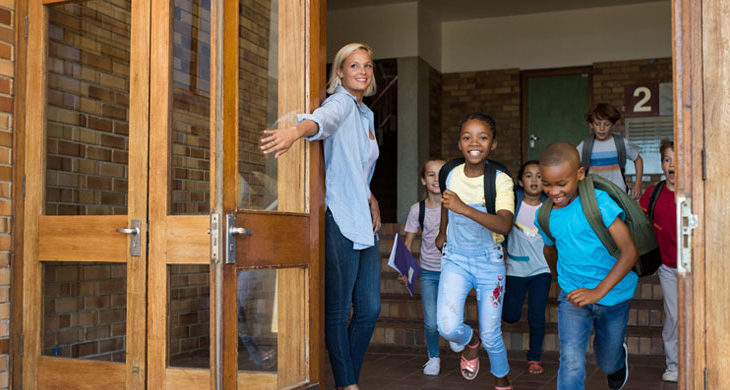 Group of elementary children leaving school for four-day school week