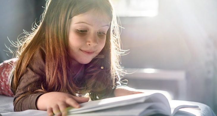 young girl reading a book
