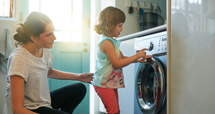 mother and daughter doing laundry
