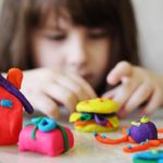 little girl playing with play-doh