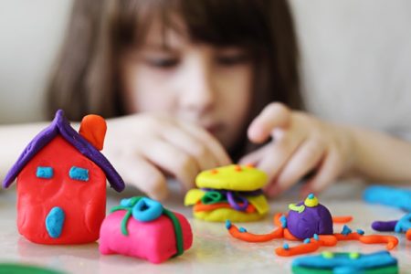 little girl playing with play-doh