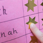 Close Up Of Child With Reward Chart