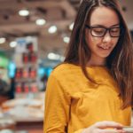 young girl look for books on school reading list