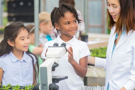 girls listening to a biologist during a class trip