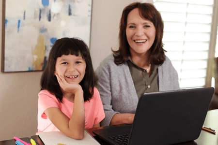 daughter and mom using laptop