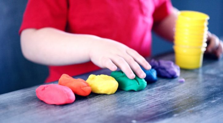 child playing with play doh