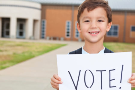 Child with vote sign